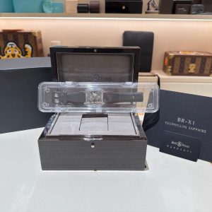 Bell & Ross BR-X1 Tourbillon Sapphire watch displayed in an open box with warranty card nearby
