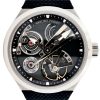 Close-up of a Greubel Forsey wristwatch showing exposed gears, black bezel, and silver case with a textured strap.