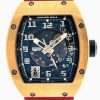 Skeleton-dial Richard Mille watch with a gold-toned case and a red strap, showing visible gears and hands.