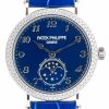 Patek Philippe Genève luxury wristwatch with blue dial, diamond-studded bezel, and moon phase subdial at 6 o'clock.