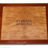 Close-up of a wooden display case with a carved panel and the inscription 'F.P. Journe Invenit et Fecit' on the front panel