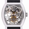 Skeleton watch with visible gears and silver case, black strap, showcasing intricate internal mechanism