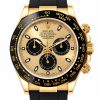 Gold Rolex Daytona chronograph wristwatch with black bezel and black strap, close-up view of face and subdials.
