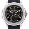Patek Philippe Geneva steel wristwatch with a black dial, large numerals, and a black rubber strap.