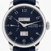 Close-up of a blue-dial wristwatch showing day, month, and date windows (Mon Jul, 19).