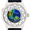 Patek Philippe world time watch with colorful globe dial and city names around the bezel, leather strap visible.