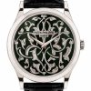 Patek Philippe wristwatch with a green dial and intricate silver floral engravings, silver case, and black leather strap.
