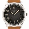 Patek Philippe wristwatch with a black textured dial, beige numerals, date window at 3 o'clock, and a tan leather strap.