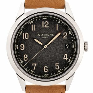 Patek Philippe wristwatch with a black textured dial, beige numerals, date window at 3 o'clock, and a tan leather strap.