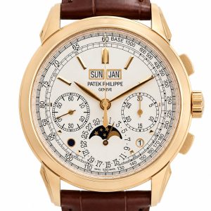 Gold-tone Patek Philippe wristwatch with white dial and brown leather strap; day, date, month, and moon-phase complications visible on the face.