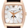Rose gold Patek Philippe wristwatch with a white dial, day indicators, date window at 12 o'clock, moon phase subdial, and brown leather strap.